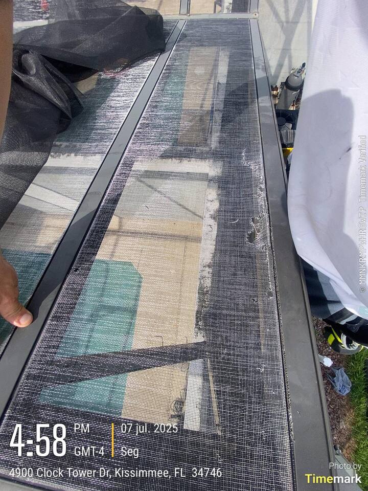 Damaged roof screen panel in Kissimmee before repair